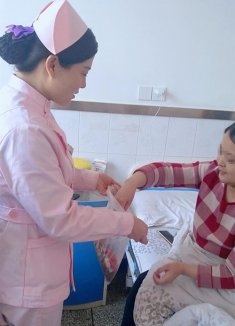 护士刘莹莹特地为住院不能回家团聚的患者们送来瓜子糖果